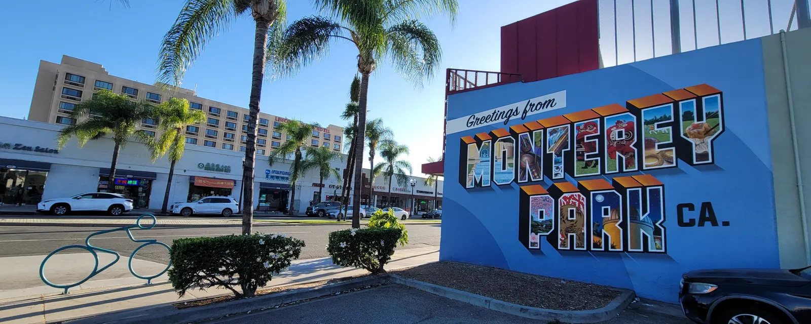 The “Greetings from Monterey Park” mural on Garvey Avenue, with the shops on the north side behind it