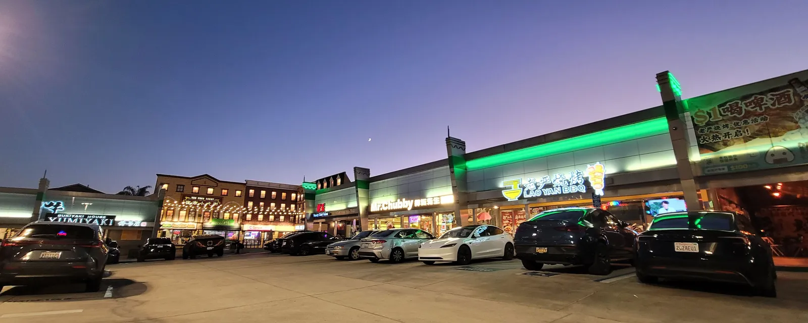 A shopping plaza in Rowland Heights lit up at dusk