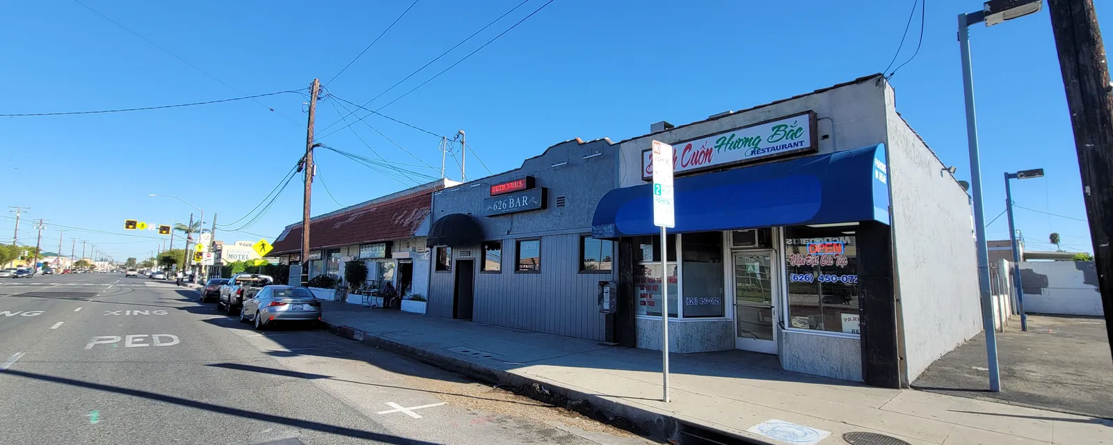 A small family-run shop with a blue awning on a Rosemead street