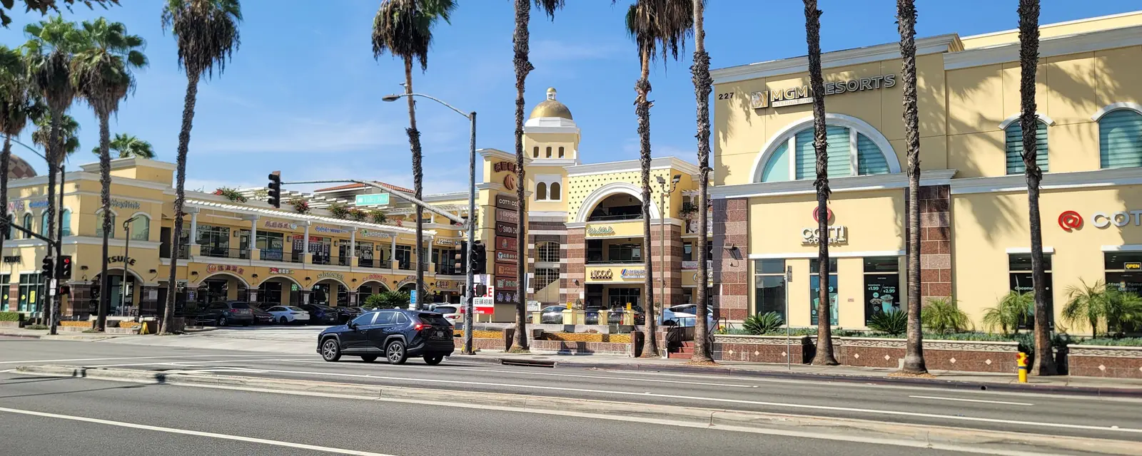 A domed shopping plaza behind a row of palm trees in San Gabriel